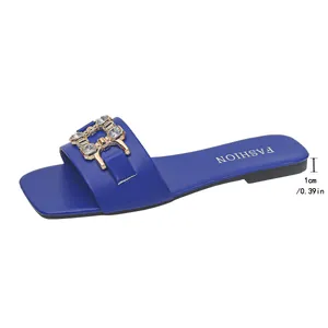 Detail shot of blue square-toe flat sandals featuring gold crystal chain and 1cm heel