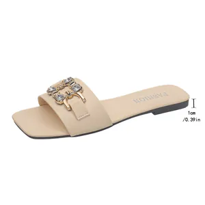 Detail view of beige square-toe flat slide sandal with 1cm heel height measurement.