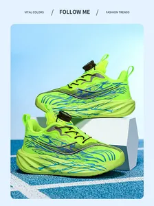 Detailed view of neon green boys' sneakers with rotary buckle and thick sole