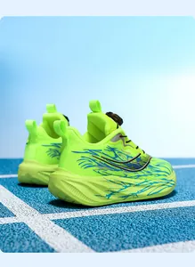 Close-up of children's neon green sports shoes featuring a rotary buckle and thick sole