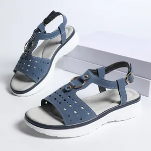 Detailed side view of blue platform sandals for women featuring laser-cut perforations