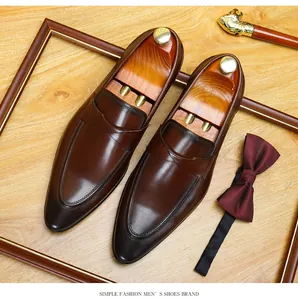 Elegant brown leather loafers with vintage finish and gentlemanly accessories