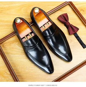 Elegant black leather loafers with wooden shoe trees and a formal burgundy bow tie