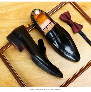 Macro detail shot of black leather men's dress shoes with a classic loafers design.