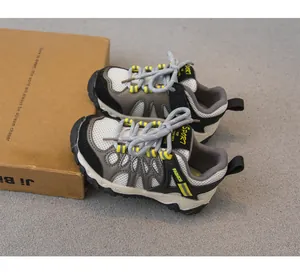 Side view of lightweight breathable outdoor hiking shoes for kids with yellow accents and mesh