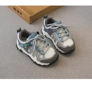 Detail view of breathable mesh kids hiking shoes with non-slip soles and blue accents.