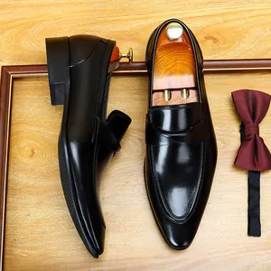 Elegant black British style men's leather formal wedding shoes on wood background