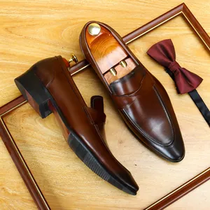 Elegant brown leather loafers for men, classic English retro style with bow tie.