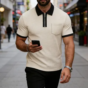 Detailed macro view of a men's zip polo shirt featuring contrast collar and pocket