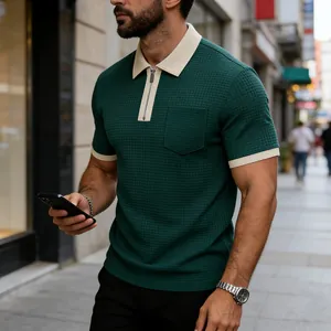 Close-up of a green waffle-textured Polo shirt with contrast collar and zipper detail.