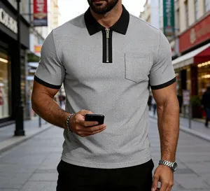 Close-up of men's grey textured Polo shirt featuring a zipper and chest pocket.