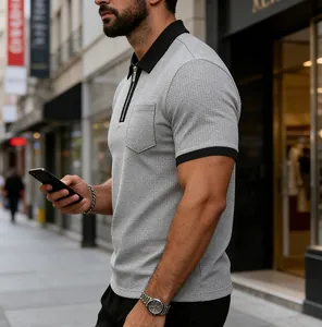 Detail of men's grey waffle knit Polo shirt with black contrast zip collar and pocket