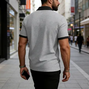 Back view of a men's textured grey Polo shirt with black contrast collar and cuffs.