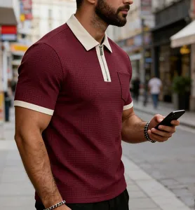 Close-up of men's wine red waffle knit zip polo shirt featuring a contrast cream collar