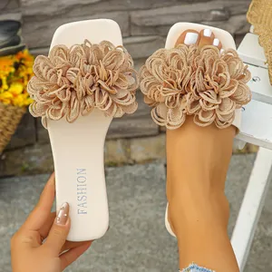 Close-up view of elegant women's flat slide featuring a large gold glittery floral decoration