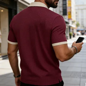 Back view of a men's burgundy polo shirt with textured fabric and contrast collar