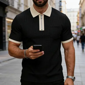 Close-up of black waffle-textured Polo shirt with contrast zipper collar