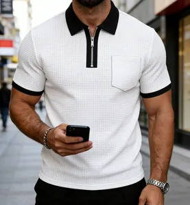 Close-up of men's white waffle knit polo shirt with black contrast zip collar and pocket