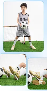 Detailed view of children's gold soccer shoes with TF turf soles on green field