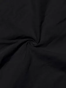 Detailed macro view of black sand-washed linen fabric texture for casual men's shirt