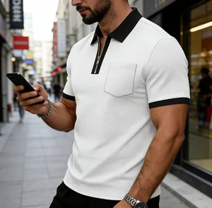 Detailed view of white zipper Polo shirt with black contrast collar and chest pocket.