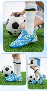 Professional blue children's soccer shoes with turf studs for artificial grass training.