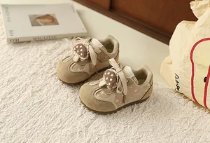 Detailed view of girls' sweet floral sneakers with cute mushroom lace accessory