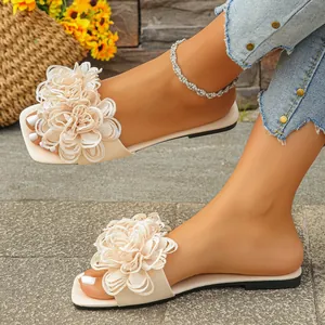 Elegant beige flat sandals with large 3D floral embellishment for summer beach outings