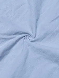 Close-up detail of light blue sand-washed breathable linen fabric texture