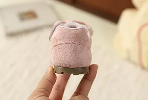 Detail of pink suede heel and textured rubber sole on sweet floral toddler girl sneaker