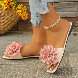 Close-up of elegant women's pink floral flat sandals with delicate lace petal details