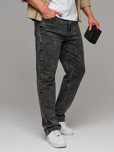 Detailed shot of men's slim fit grey acid-washed jeans featuring a tapered leg design