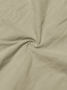 Macro view of breathable sand-washed linen fabric texture in light beige color