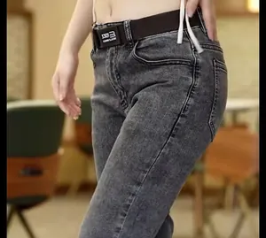 Close-up detail of grey washed slim fit denim jeans for men featuring a stylish belt buckle