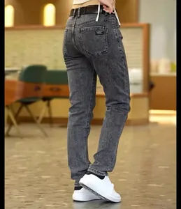 Back view of men's slim-fit grey acid-wash denim jeans with pocket detail