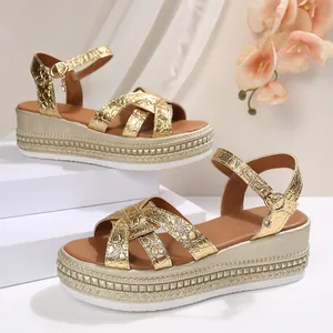 Detail of women's gold platform wedge sandals with crocodile texture and ankle strap buckle