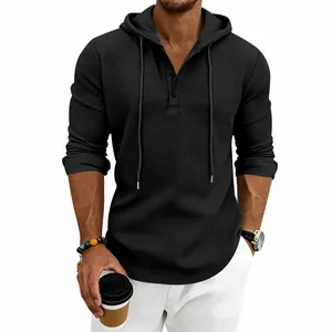 Close-up of black waffle knit hooded Henley shirt for men with three-button placket.