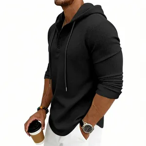 Detailed close-up of a black waffle knit Henley hoodie for men featuring long sleeves