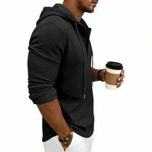 Side view detail of a men's black waffle knit hoodie with a Henley collar and hood