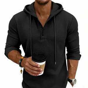 Detailed view of black men's waffle knit hooded Henley shirt with button neckline
