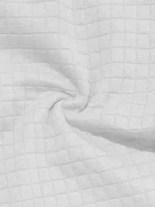 Close-up of white waffle texture fabric showing grid pattern details.