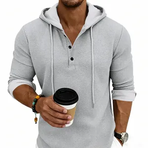 Close-up of men's grey waffle knit hoodie showing fabric texture and Henley buttons