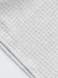 Close-up detail of grey quilted texture fabric for men's casual sportswear set