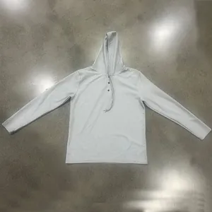 Close-up detail of a light grey waffle knit men's hoodie Henley shirt with long sleeves