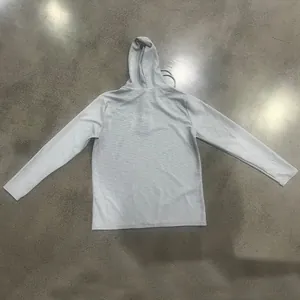 Back view of a light gray waffle-knit hoodie with long sleeves and drawstring hood