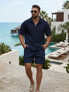 Man wearing a navy blue waffle knit polo shirt and shorts set in a luxury resort