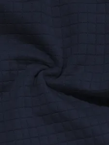 High-definition macro shot of navy blue checkered waffle fabric for men's polo