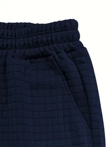 Macro view of navy blue waffle texture fabric and elastic waistband of men's casual shorts