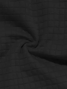 Macro shot of breathable black waffle knit fabric for men's summer polo sports set.