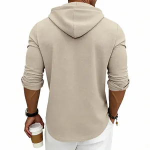Detailed back view of a men's relaxed waffle knit hoodie in a neutral beige color tone